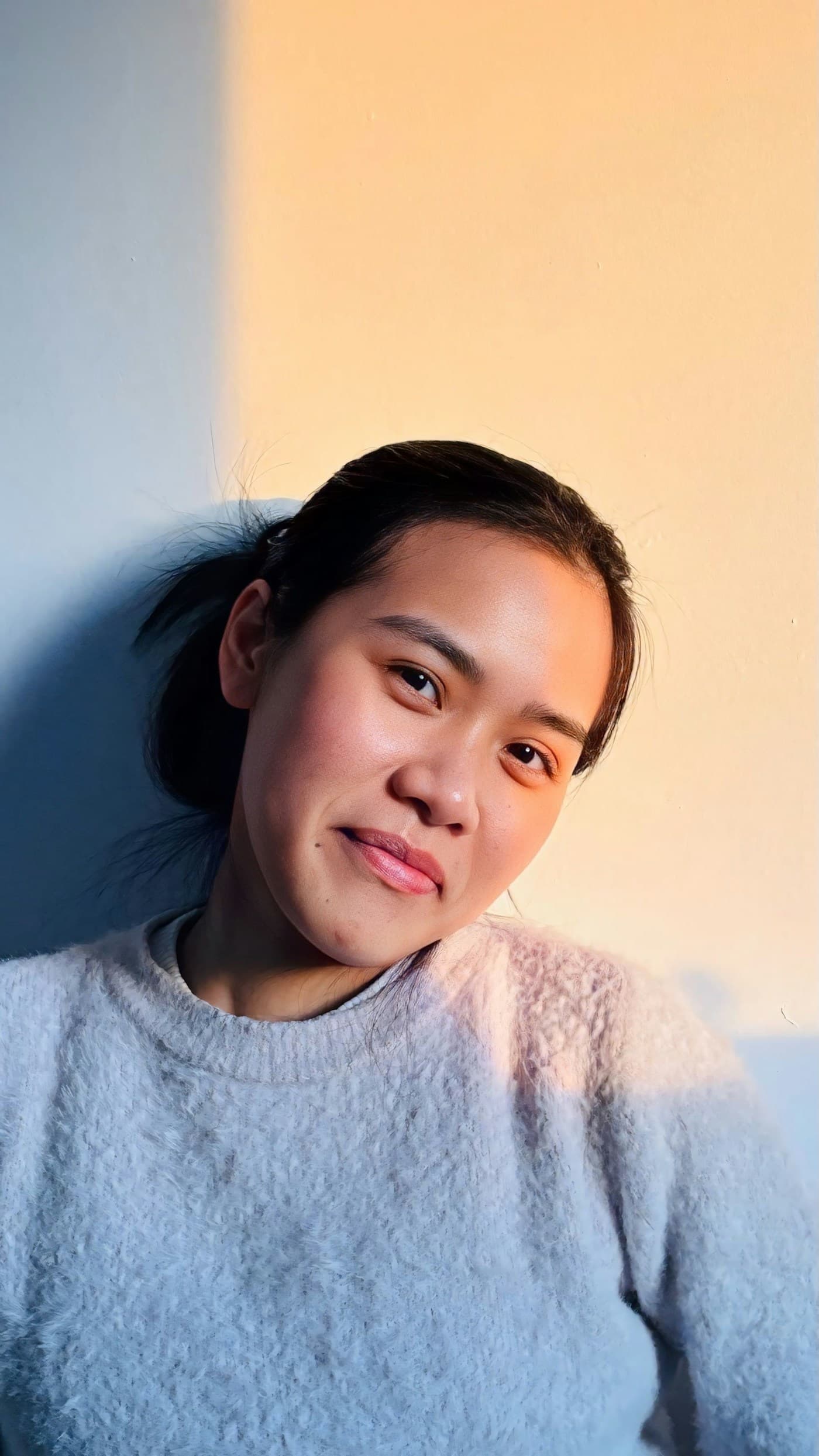 A customer smiling in warm natural light